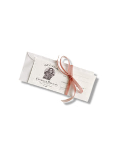 Freckles and Porcelain Gift Card tied with a bow
